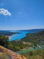 magnificent lake of Sainte-Croix with clear crystalline waters, incredible view of blue waters where you can sunbathe, do sports such as canoeing, lake surrounded by nature, trees, rocks. Sunny day photo