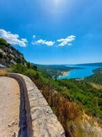 magnificent lake of Sainte-Croix with clear crystalline waters, incredible view of blue waters where you can sunbathe, do sports such as canoeing, lake surrounded by nature, trees, rocks. Sunny day photo