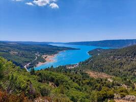 magnificent lake of Sainte-Croix with clear crystalline waters, incredible view of blue waters where you can sunbathe, do sports such as canoeing, lake surrounded by nature, trees, rocks. Sunny day photo