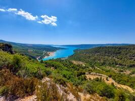 magnificent lake of Sainte-Croix with clear crystalline waters, incredible view of blue waters where you can sunbathe, do sports such as canoeing, lake surrounded by nature, trees, rocks. Sunny day photo