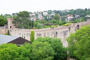 Tourists walking on top of ancient girona city wall in spain photo