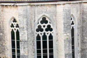 Sunlight passing through three gothic style church windows photo