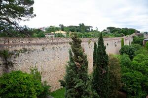 Tourists walking on top of ancient girona city wall in spain photo