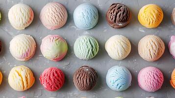 A close-up of an assortment of colorful ice cream scoops arranged in rows on a gray background. photo