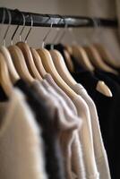 Close up of hanging clothes hang on wooden hangers generated by AI photo