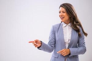 Portrait of cheerful businesswoman who is pointing at space for text or product. photo