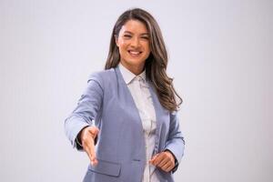 Portrait of cheerful businesswoman who is looking at camera and handshaking. photo