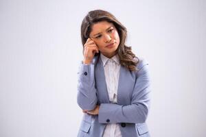 Portrait of pensive and exhausted businesswoman who is looking away and thinking. photo