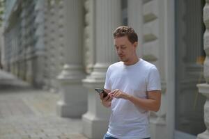 A man on the street using a smartphone. Concept of communication in social networks and messengers. photo