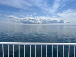 Sea view from the deck of a cruise ferry ship. Calm water without waves photo