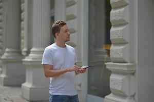 A man on the street using a smartphone. Concept of navigating in the city and using mobile maps. photo