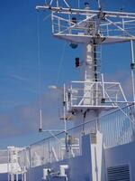 Radar antennas on board of a cruise ferry ship. Navigation system of the liner. Elements of radio location equipment in the ultrasonic wave range. photo