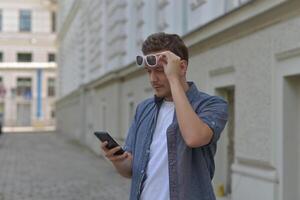 A man on the street using a smartphone. Concept of communication in social networks and messengers. photo