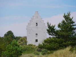 Den Tilsandede Kirke in Skagen, Denmark. A famous ancient buried in dune church, earlier partially covered with sand photo