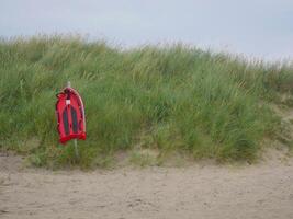 Life saving rescue board on the beach in Skagen. Lifeguard preserving buoy for self-usage. The concept of safety on water. photo