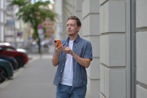 A man on the street using a smartphone. Concept of navigating in the city and using mobile maps. photo