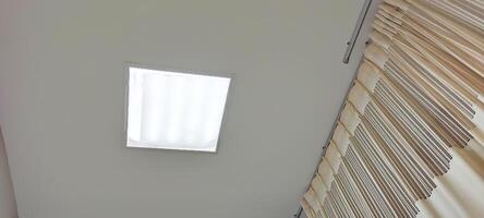 Background view of the ceiling of a hospital patient's room from the perspective of a bedridden patient. Clinical healthcare recovery treatment room ward. photo
