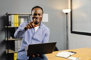 Man typing on laptop computer photo