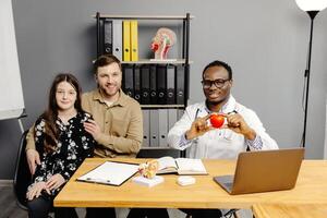Group of people sitting in front of whiteboard in doctors offices photo