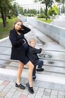 Pregnant mother and her little son walking and funny spending time together photo