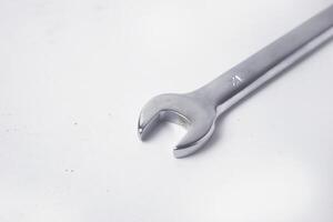 Wrenches 10 and 12 are used to service several items on a white background photo