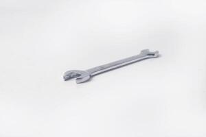 Wrenches 10 and 12 are used to service several items on a white background photo