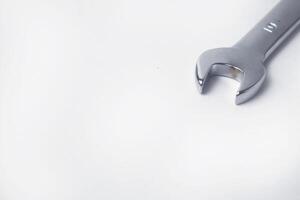Wrenches 10 and 12 are used to service several items on a white background photo