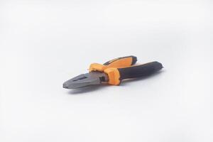 The photo from the side a pair of pliers with a yellow handle