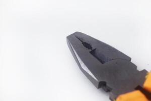 Closeup photo of a pair of pliers with a yellow handle on a white background