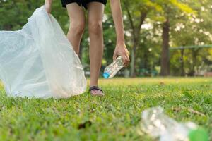 Save earth. Volunteer pick up trash garbage at the park and plastic bottles are difficult decompose prevent harm. Earth, Environment, Greening planet, reduce global warming, Save world ,pollution photo