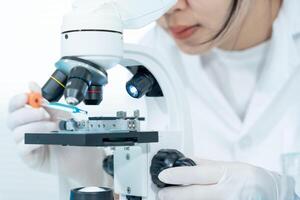 Scientist analyze biochemical samples in advanced scientific laboratory. Medical professional use microscope look microbiological developmental of viral. Biotechnology research in science lab. photo