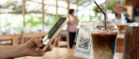 Woman use smartphone to scan QR code to pay in cafe restaurant with a digital payment without cash. Choose menu and order accumulate discount. E wallet, technology, pay online, credit card, bank app. photo