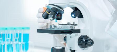 Scientist analyze biochemical samples in advanced scientific laboratory. Medical professional use microscope look microbiological developmental of viral. Biotechnology research in science lab. photo