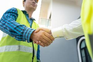 Construction team hands shaking greeting start up plan new project contract in office center at construction site, industry ,architecture, partner, teamwork, agreement, property, contacts. photo