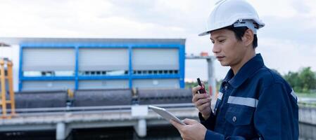 maintenance and inspector. Maintenance engineers are using tablet to checking results of inspection of buildings and structures. Irrigation engineers are exploring sluice systems photo