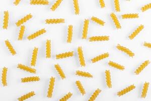 Pasta products in the form of a spiral, texture, on a white background photo
