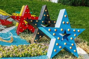 sculptures of multi-colored stars on a background of grass photo