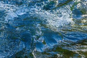 flow of water and spray from a stone photo
