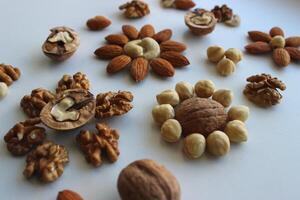 Different Types Of Nuts In Form Of Flowers On White Surface Angle View photo