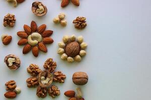 Concept For Titles Or Logo With Flowers Made Of Nuts Kernels In A Half Of Image photo
