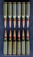 Top view of twelve bullets in two groups lined up head to head on clean black fabric. Stock Photo For Vertical Bullets Backgrounds