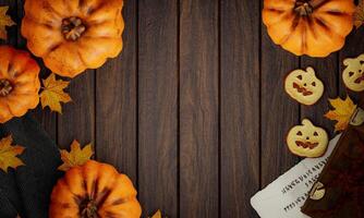 Top view Halloween concept. Decorations, pumpkins, cookies and maple leaf on wood background. Halloween party greeting card, Poster, headers for website mockup with copy space. 3d render. photo