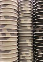 Multi colored cardboard coffee cups with pattern nested inside one another illustrating the coffee scale photo