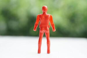 Back view of Red model of human plastic toy. Concopt, Toy for kids, enhance imagination in childhood with toy characters of superhero. Fantasy comic fiction from cartoons, movie. photo