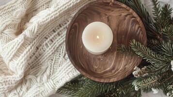 Christmas scented candle on the wooden round plate and christmas trees, Boho Decor photo