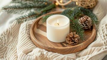 Christmas scented candle on the wooden round plate and christmas trees, Boho Decor photo