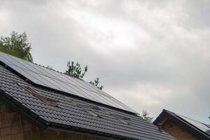 House roof with photovoltaic modules. photo