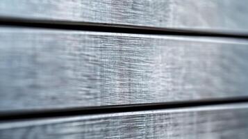 Close up of a brushed metal background with horizontal grain texture silver and gray tones photo