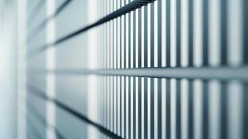 Close up of a sleek wall with light highlighting vertical grooves modern architecture light gray tones photo