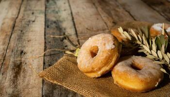Copy Space image of Donuts with powdered sugar on wooden table on black background photo